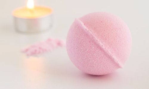 Create your own fizzy bath bombs using baking soda, citric acid, essential oils, and dried flowers for a relaxing spa experience.